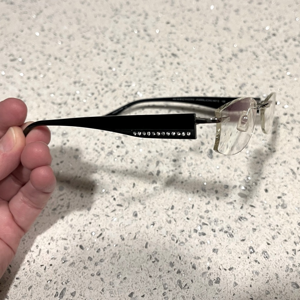 Airlock Rimless Frames in Black w/ simulated diamonds for temple decor.